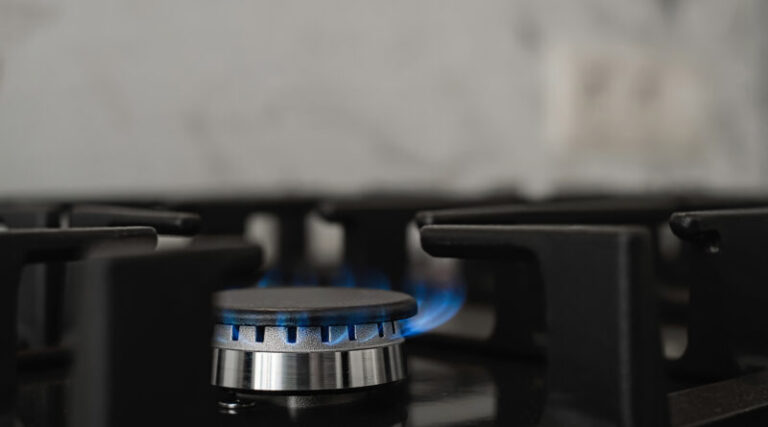 Modern kitchen stove, natural gas burns with a blue flame. Household gas consumption