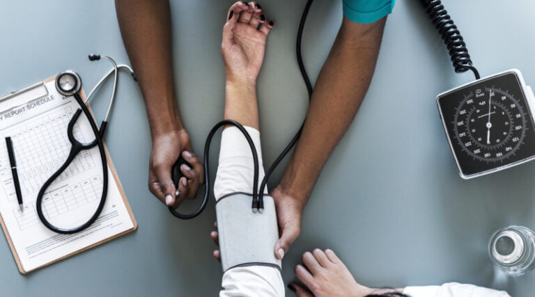 Nurse measuring patient blood pressure