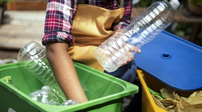 Closeup of hands separating plastic bottles